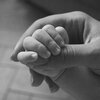 Parent Holding a Baby's Hand